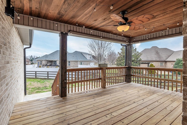 deck with ceiling fan, a residential view, and fence