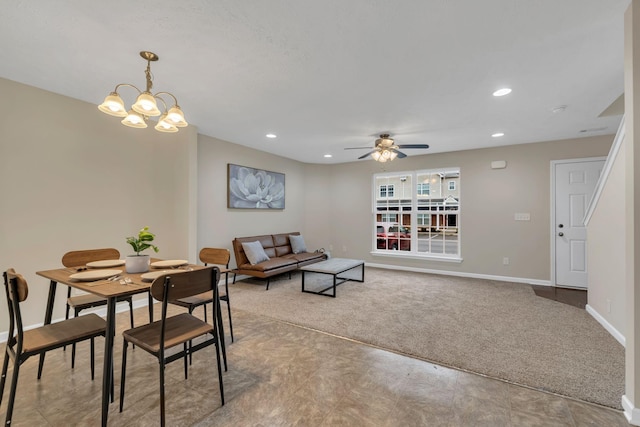 dining area with light colored carpet and ceiling fan with notable chandelier