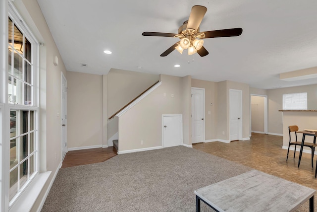 living room with ceiling fan, a healthy amount of sunlight, and carpet