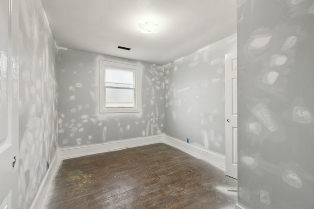 spare room featuring dark hardwood / wood-style floors