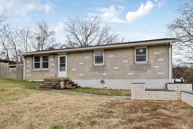 rear view of property featuring a yard