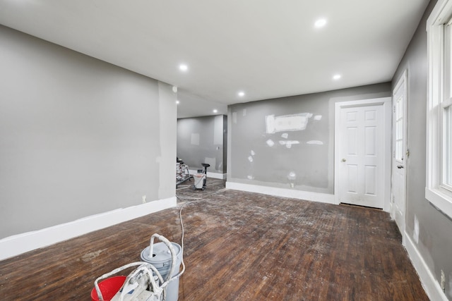 basement with dark hardwood / wood-style floors