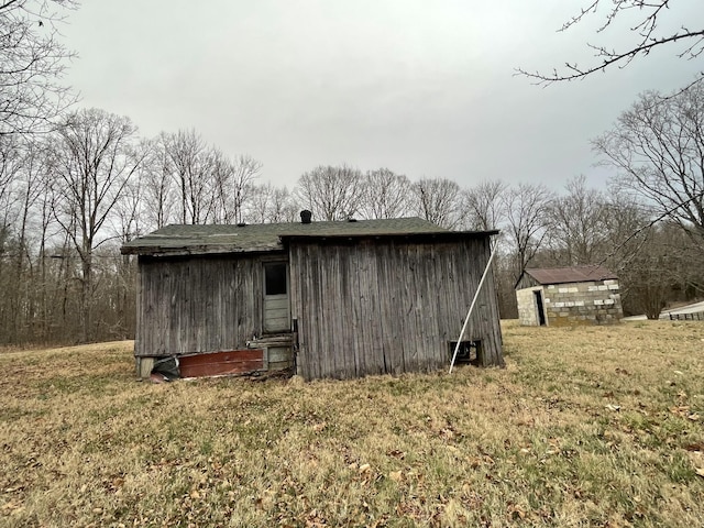 view of outbuilding featuring a lawn