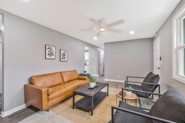 living room with ceiling fan, hardwood / wood-style floors, and a wealth of natural light