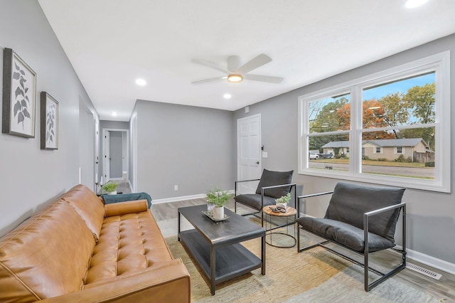 living room featuring ceiling fan and light hardwood / wood-style floors