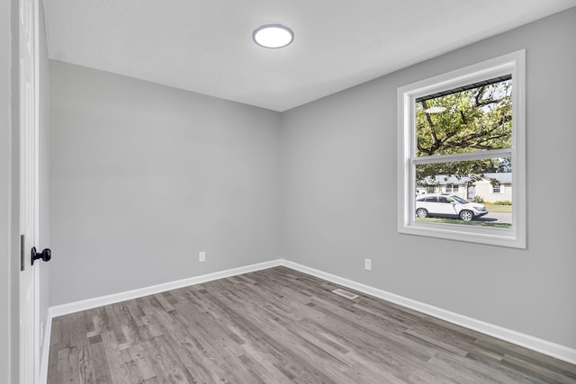 spare room featuring light hardwood / wood-style flooring