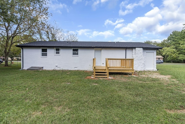 rear view of property with a lawn and a deck