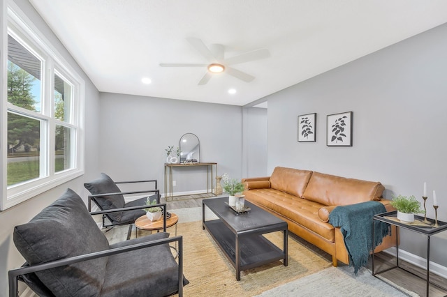 living room with light hardwood / wood-style floors and ceiling fan