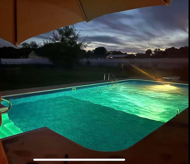 view of pool at dusk