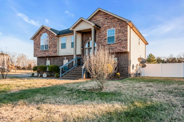 raised ranch featuring a front yard