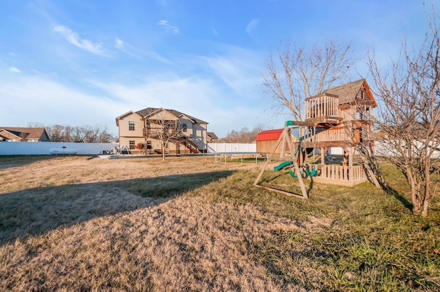 view of yard featuring a trampoline and a playground