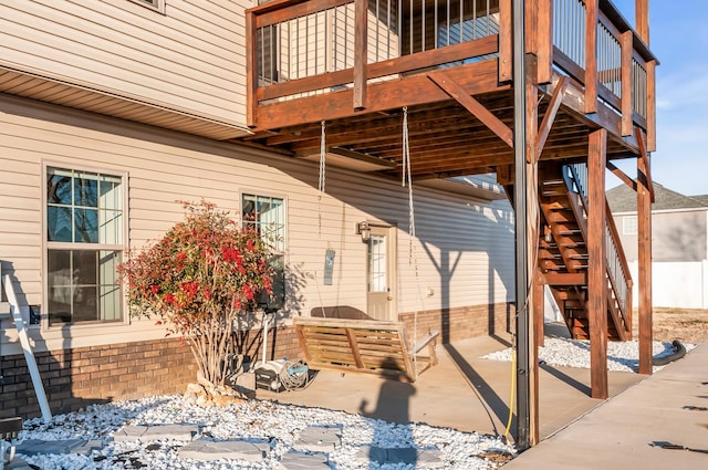 snow covered patio featuring a wooden deck