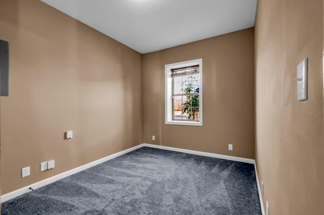 empty room with dark colored carpet