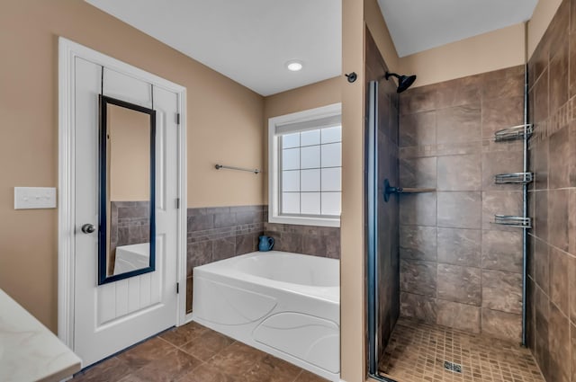 bathroom featuring tile patterned floors and separate shower and tub