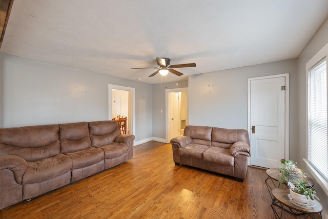 living room featuring light hardwood / wood-style floors and ceiling fan