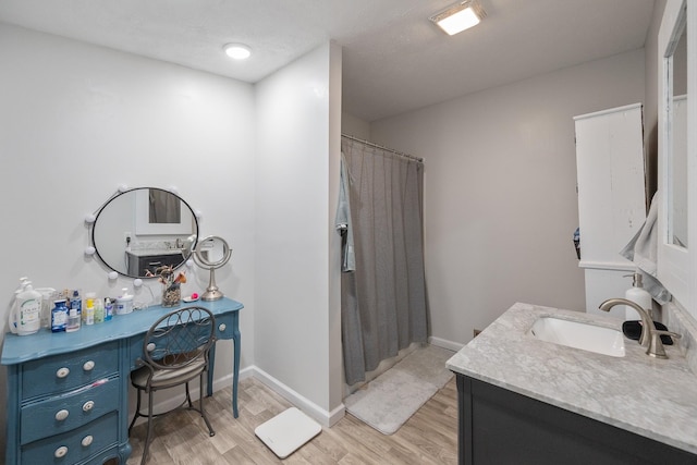 bathroom with vanity and wood-type flooring