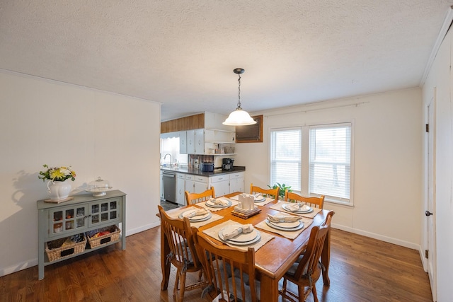 dining area with dark hardwood / wood-style floors, sink, and a textured ceiling