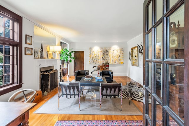 dining space featuring hardwood / wood-style floors and ornamental molding