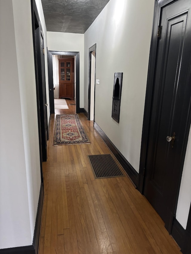 corridor featuring hardwood / wood-style flooring