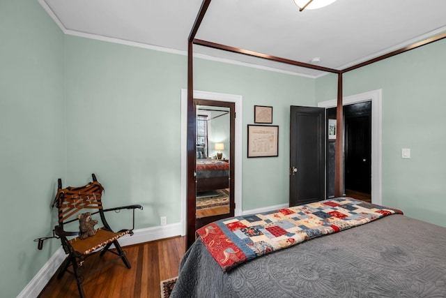 bedroom with hardwood / wood-style floors and crown molding