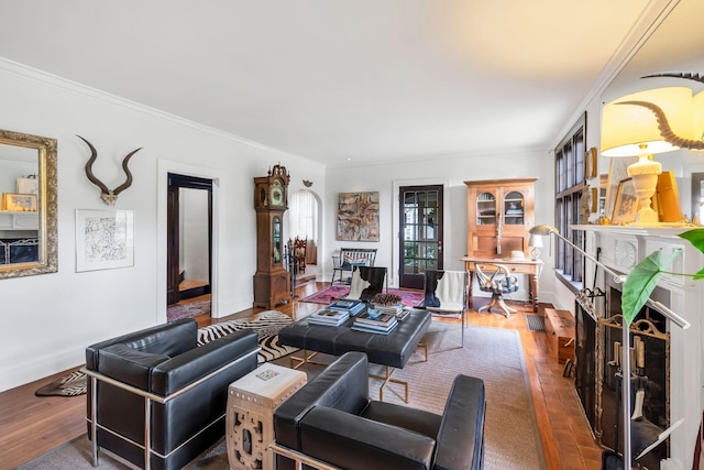 living room with crown molding and hardwood / wood-style flooring