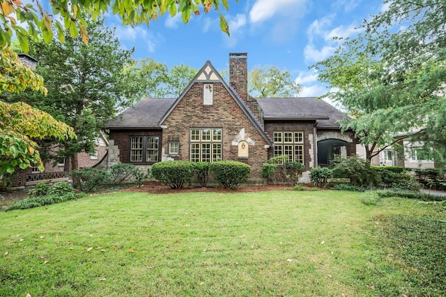 rear view of property with a lawn