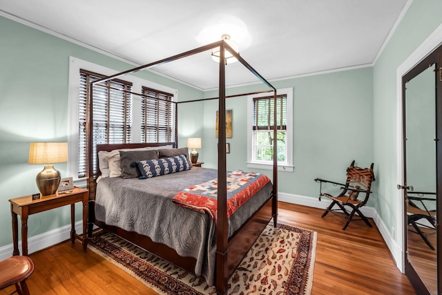 bedroom with crown molding and hardwood / wood-style flooring