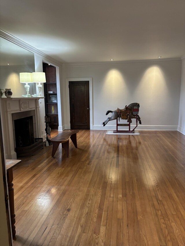 living room featuring crown molding and hardwood / wood-style floors