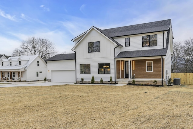 modern farmhouse featuring a garage, a porch, cooling unit, and a front yard