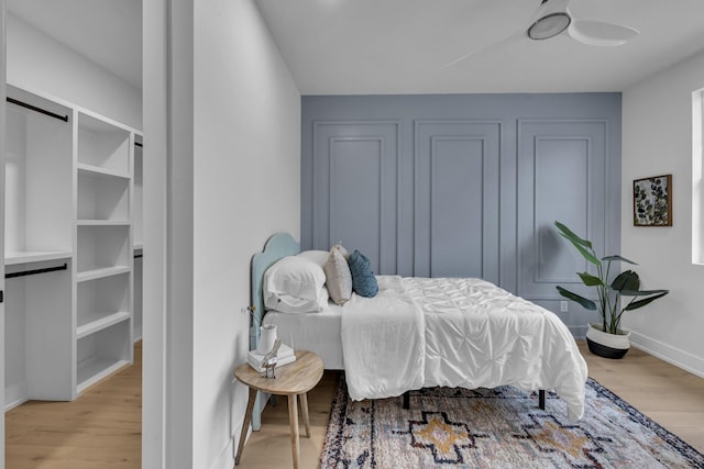 bedroom featuring a barn door and light wood-type flooring