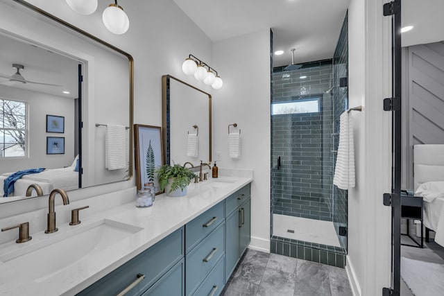 bathroom with ceiling fan, vanity, and a shower with door