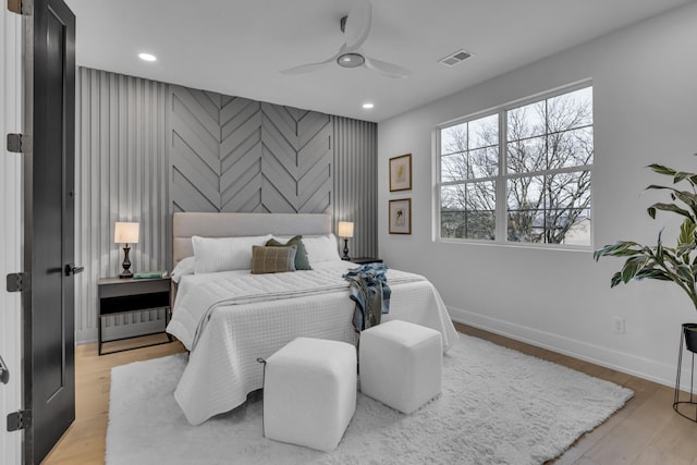 bedroom with ceiling fan and light hardwood / wood-style flooring