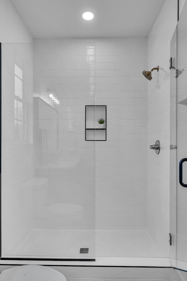 bathroom featuring toilet and walk in shower