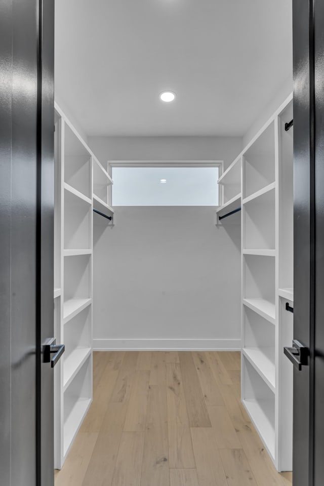 spacious closet featuring light hardwood / wood-style floors