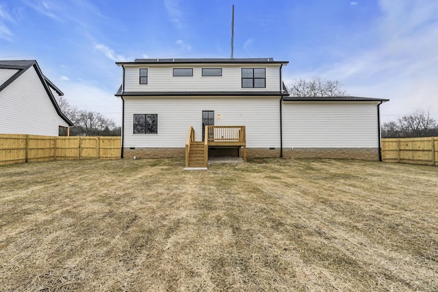 rear view of house with a yard and a deck