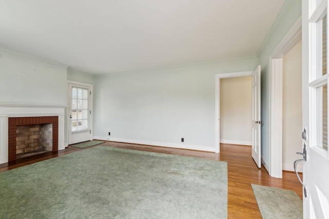 unfurnished living room with crown molding, wood-type flooring, and a fireplace