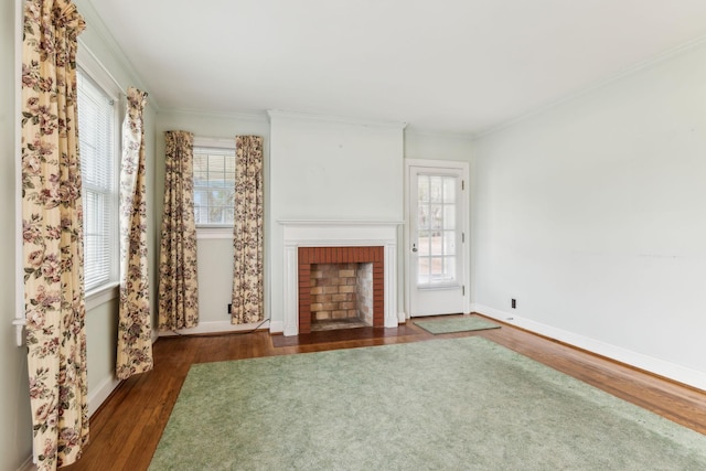 unfurnished living room featuring dark wood-type flooring, crown molding, and a brick fireplace