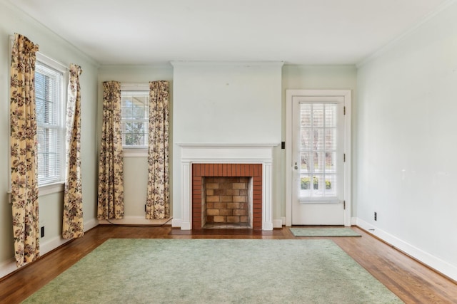 unfurnished living room featuring a healthy amount of sunlight, a fireplace, and hardwood / wood-style floors