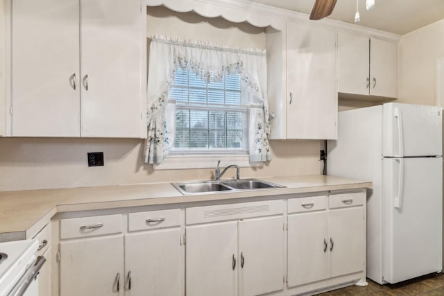 kitchen featuring white fridge, sink, white cabinets, and ceiling fan