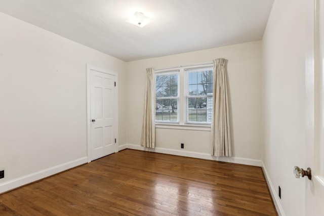 spare room with dark hardwood / wood-style floors