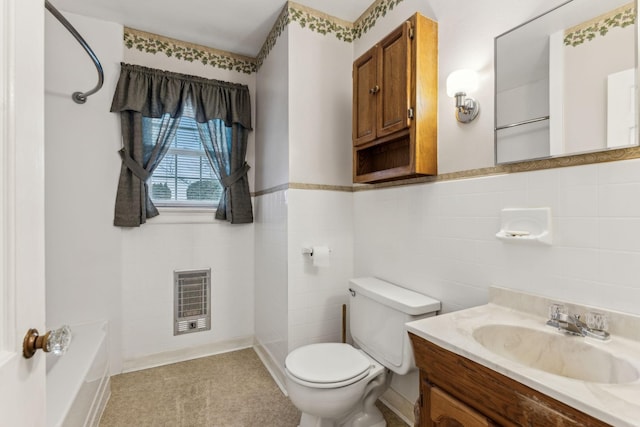 bathroom with toilet, heating unit, tile walls, vanity, and a bathtub