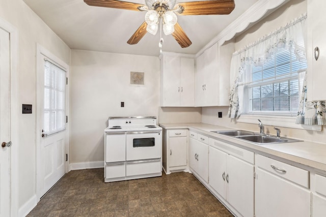 kitchen with sink, ceiling fan, white cabinets, and range with two ovens