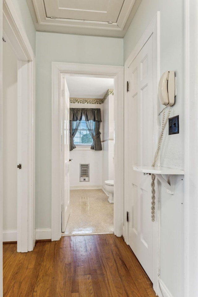 hall featuring hardwood / wood-style flooring and heating unit