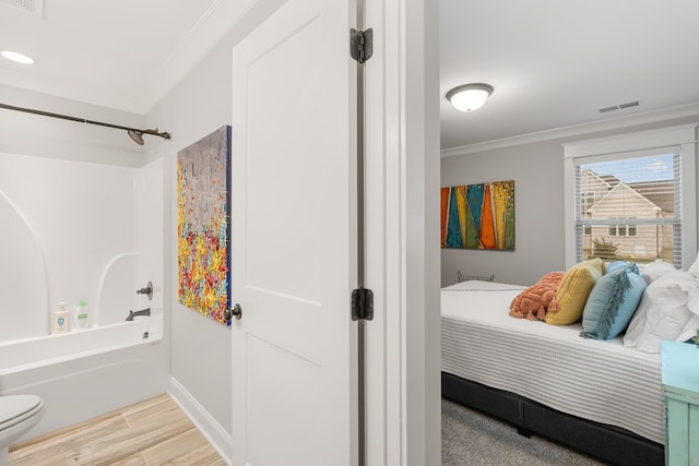 bedroom with crown molding and light hardwood / wood-style flooring