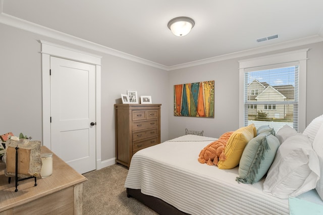 bedroom with ornamental molding and carpet flooring