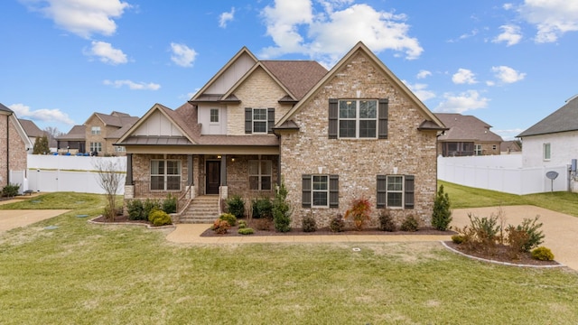 craftsman inspired home with a porch and a front yard