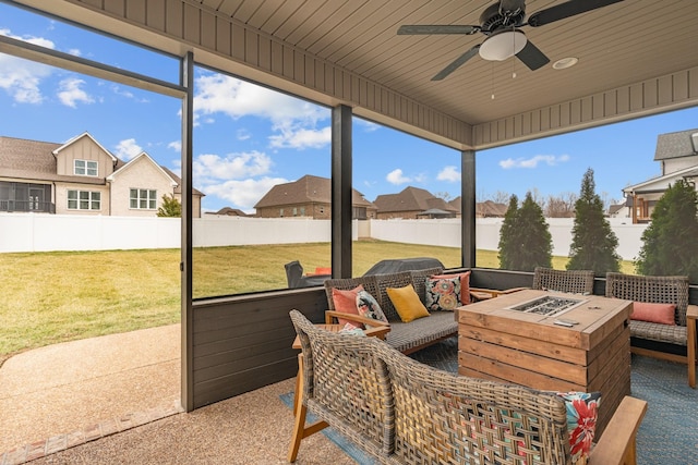 sunroom / solarium featuring wooden ceiling and ceiling fan