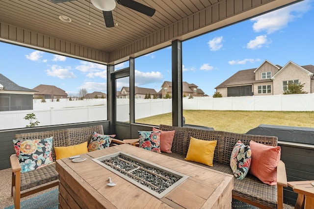 view of patio featuring ceiling fan and a fire pit