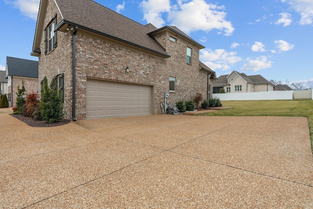 view of home's exterior with a garage and a yard