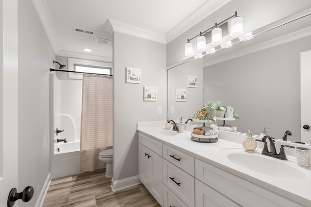 full bathroom featuring crown molding, hardwood / wood-style flooring, shower / tub combo, vanity, and toilet